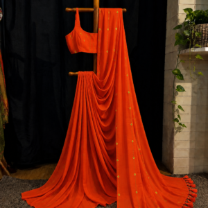 Marigold Lines — Orange Saree with Floral Butis & Tassel Border