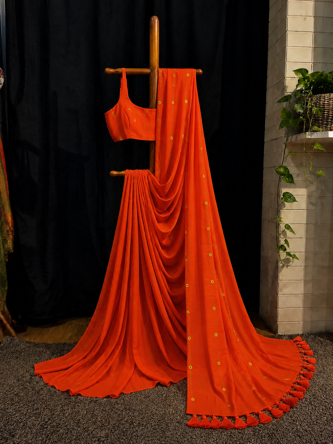 Marigold Lines — Orange Saree with Floral Butis & Tassel Border